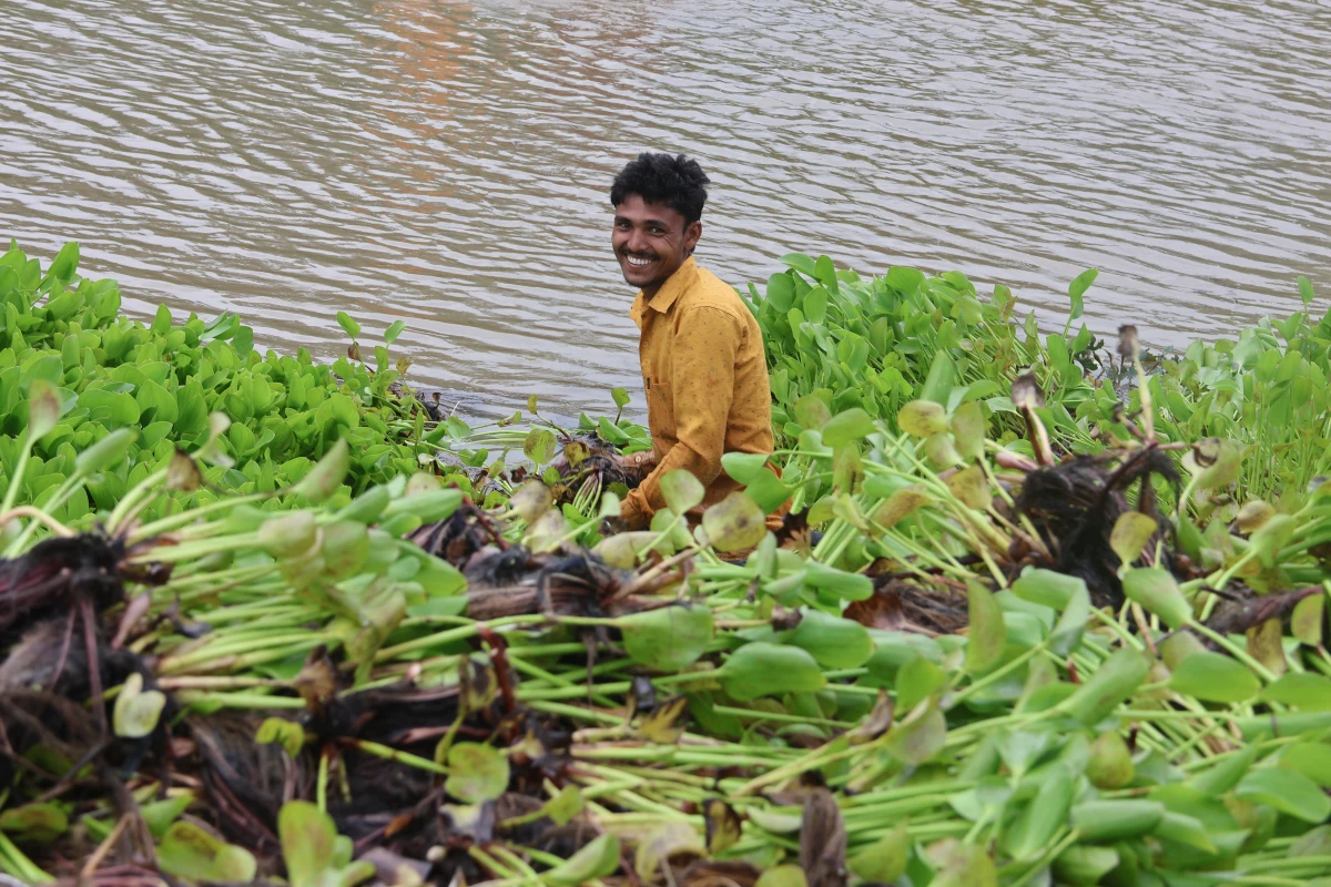 Resident cleaning a community pond under the cash-for-work programme during drought response