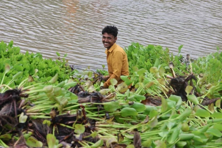 Resident cleaning a community pond under the cash-for-work programme during drought response