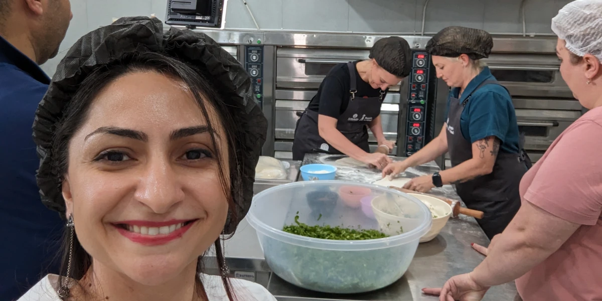 Chef Amanda Freitag baking Zhingyalov Hats and Gata with the NK displaced women at the Mets & More Bakery