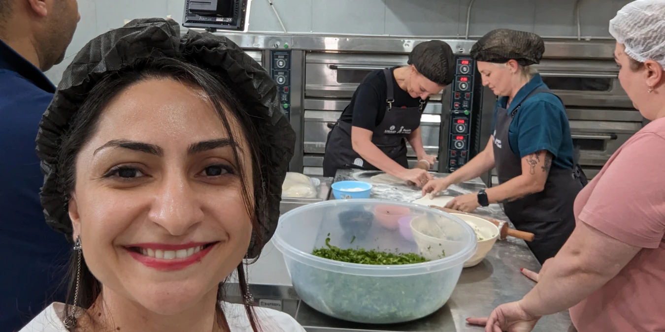 Chef Amanda Freitag baking Zhingyalov Hats and Gata with the NK displaced women at the Mets & More Bakery