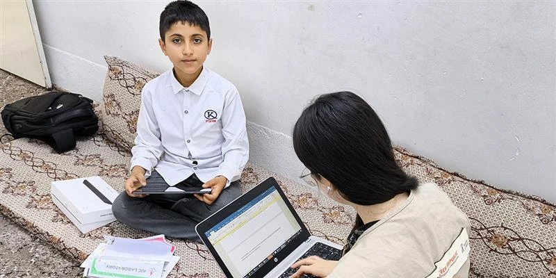 Eisa is in his room in Erbil Iraq, with PIN's staff playing PIN's environmental game after receiving the tablet