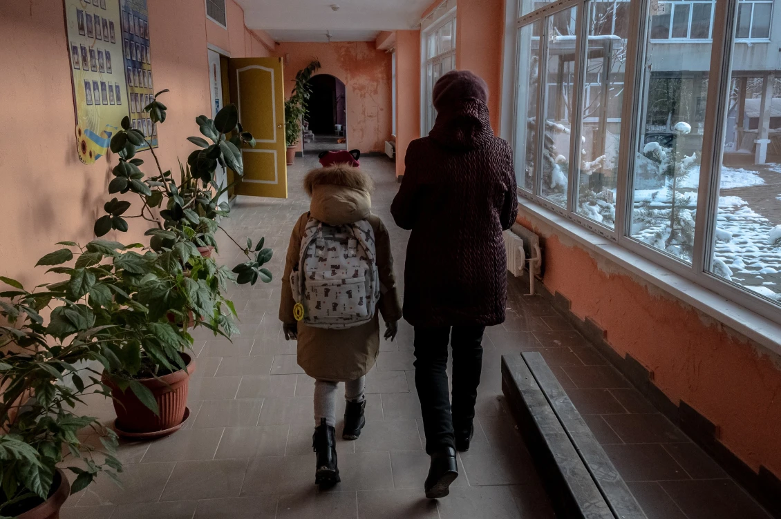 Online learning is the primary mode, but there are also separate events held at school. A mother brings her daughter to a safety lesson. 