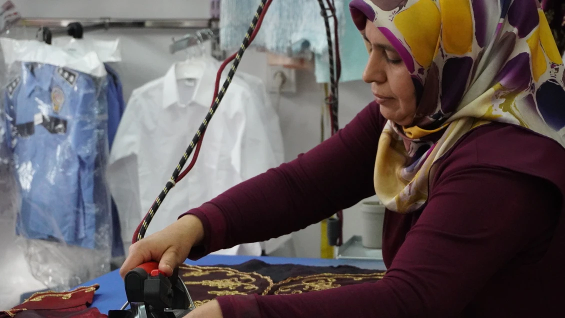 Nurten at work making clothes in her workshop.