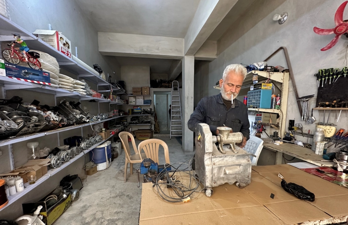 Ahmed is working in his shop.