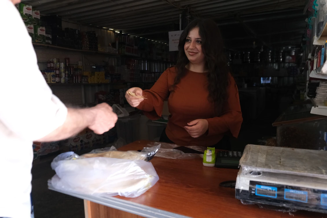Rodan, 19, working in a grocery shop in Basirma Camp, Kurdistan Iraq. 