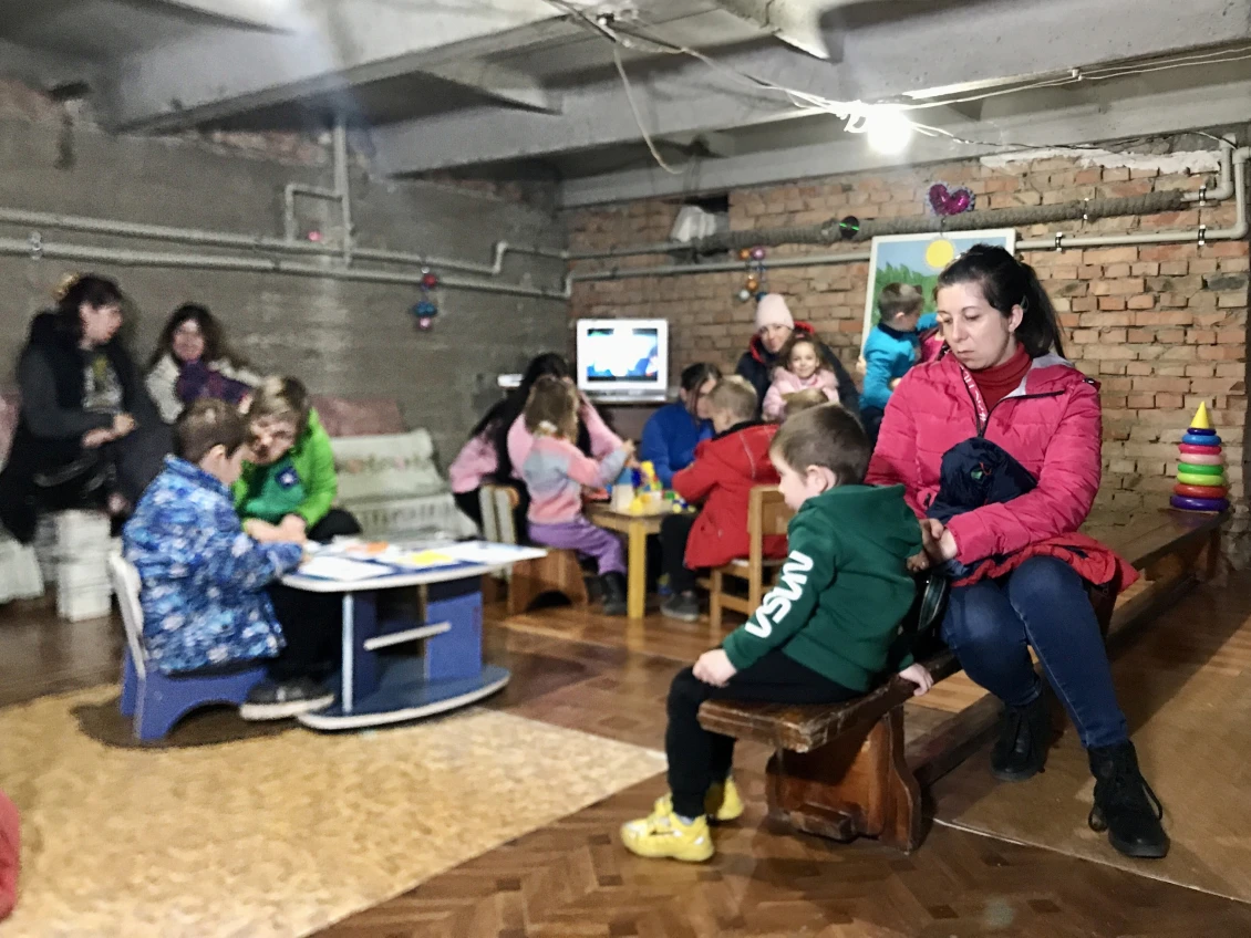 Children wait out the air raid in a shelter 