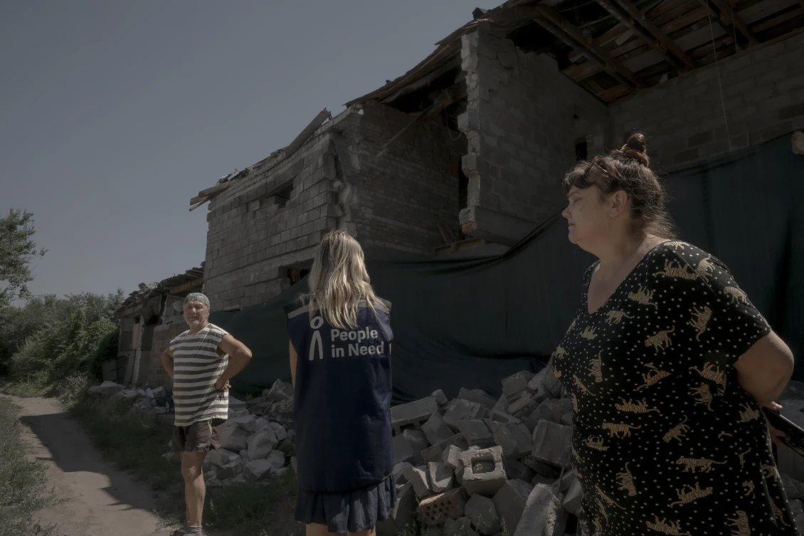 The Hetmanchuk family on the ruins of farm buildings 