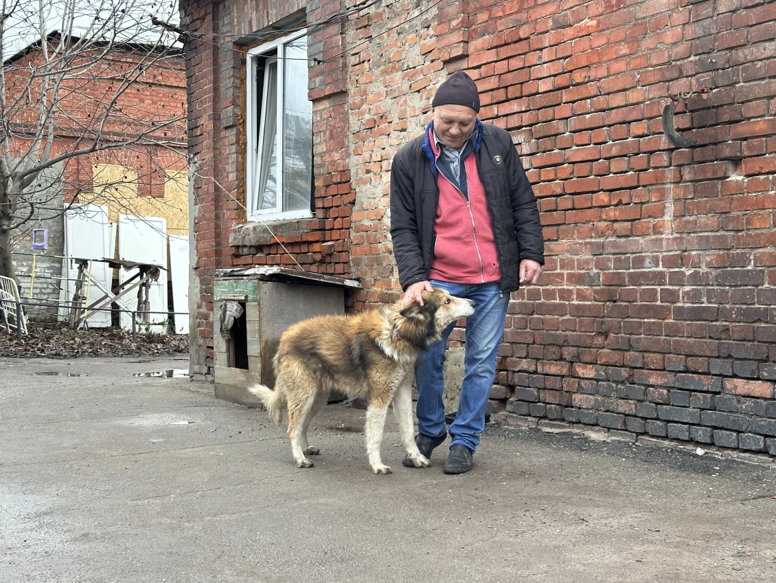 Serhii with his beloved dog Malysh, who suffered a concussion in an explosion