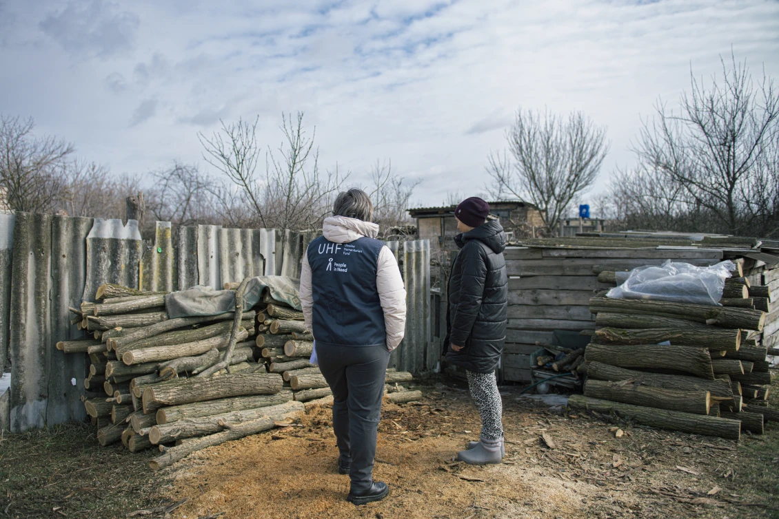 Tetiana shows the firewood she bought with our financial assistance 
