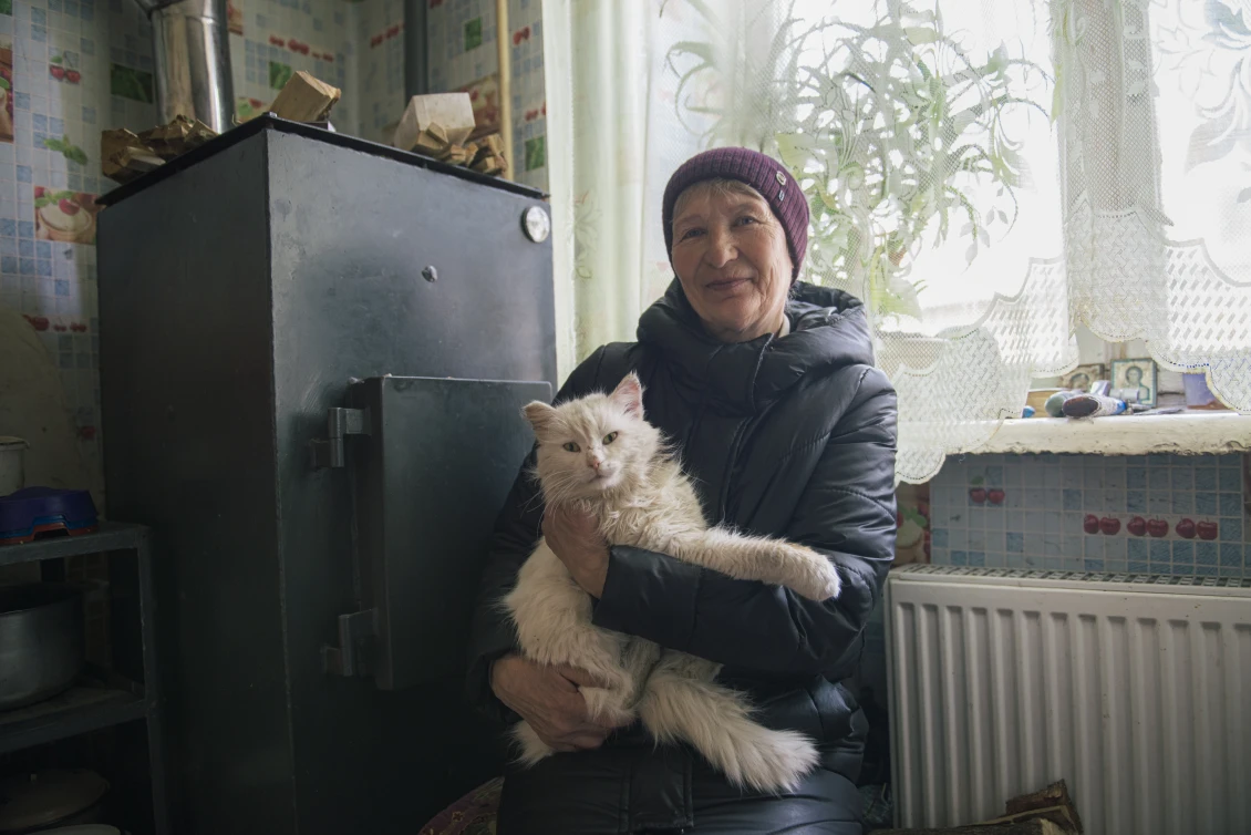 Tetiana and her cat warming-up by the new boiler 