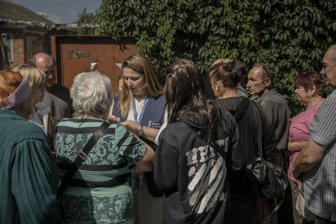 Anastasiia registers residents of the Derhachi community for vouchers