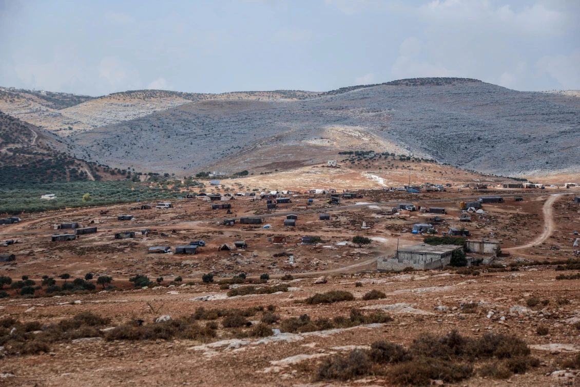 The bare countryside where Basha and hundreds of other displaced Syrians have attempted to make a temporary home. 