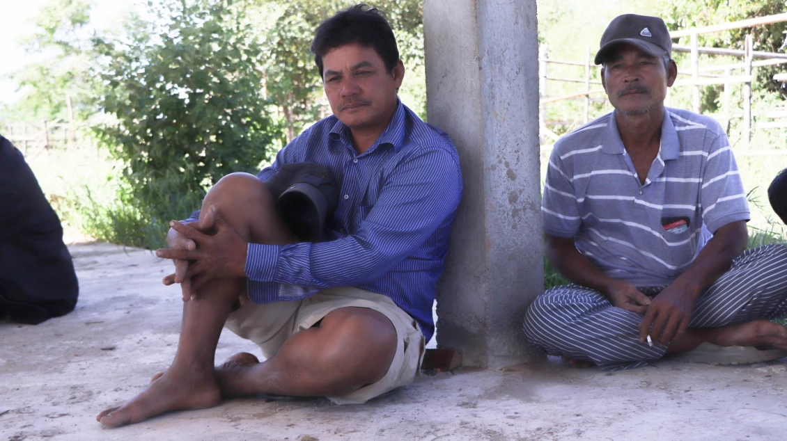 Vuthy sitting with his people at the safe site 